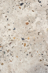 Abstract texture of light concrete with colored pebbles