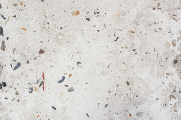 Abstract texture of light concrete with colored pebbles