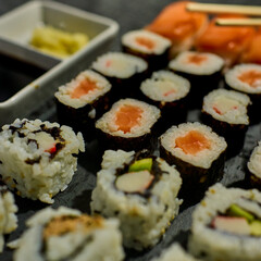 Black slate tray with assorted sushi pieces