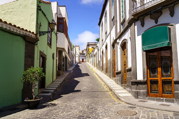 Typical streets of a small Canarian town with white houses and bright colors. Arucas Gran Canaria.