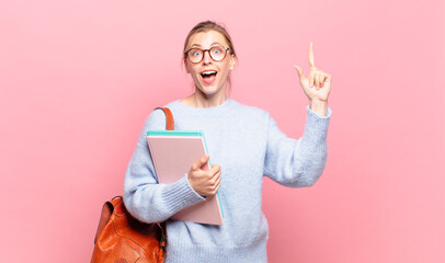 young pretty student feeling like a happy and excited genius after realizing an idea, cheerfully...