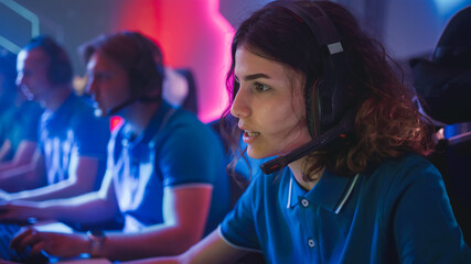 Pro Girl Plays Computer Video Game Talking into Headset on a Championship. Diverse Esport Team of Pro Gamers Play in Mock-up Video Game. Stylish Neon Cyber Games Arena. Portrait Shot