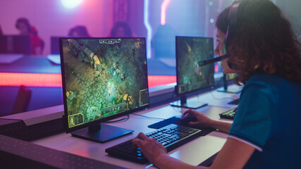 Pro Girl Plays Computer Game Plays RPG Strategy on a Championship. Diverse Esport Team of Pro...
