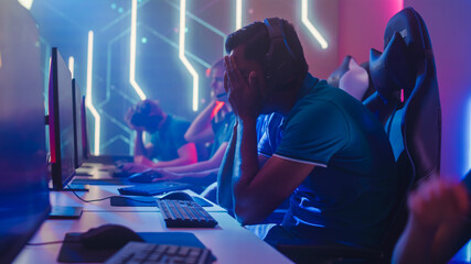 Diverse Esport Team of Pro Gamers Playing in Video Game, use Headsets to Talk, Lose Championship Disappointed. Stylish Neon Cyber Games Arena. Online Broadcasting of Tournament Event