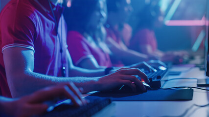 Diverse Esport Team of Pro Gamers Playing in Video Game on a Championship. Focus on Hands, Keyboards and Mouse. Stylish Neon Cyber Games Arena. Online Tournament Event.  © Gorodenkoff