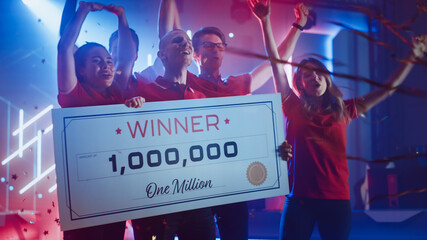 Diverse Gamers Esport Team Winner of the Video Games Tournament Celebrates Victory Cheering and Holding $1,000,000 Prize Money Presentation Check. Championship Arena Online Streaming of Cyber Games  © Gorodenkoff
