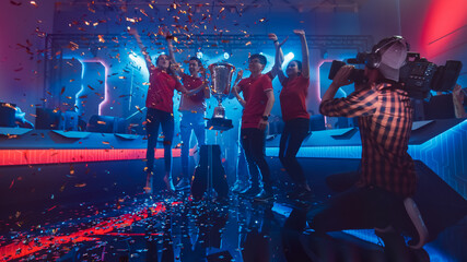 Diverse Esport Team Winner of the Video Games Tournament Celebrates Victory Cheering and Holding...