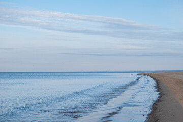 Calm Baltic Sea during sunny day with blue sky and some clouds near Carnikava, Latvia