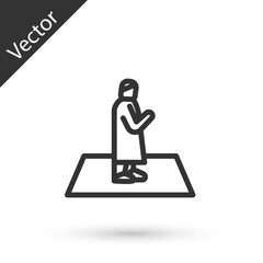 Grey line Muslim man prays on the carpet icon isolated on white background. Vector