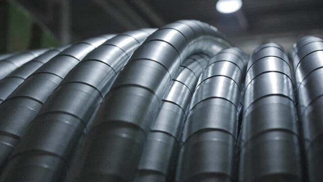 Close-up of winding a power reinforced cable on a coil at the factory.