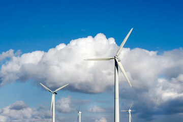 Wind turbines on a background of blue sky with white clouds