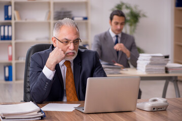 Two employees sitting at workplace