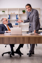 Two employees sitting at workplace