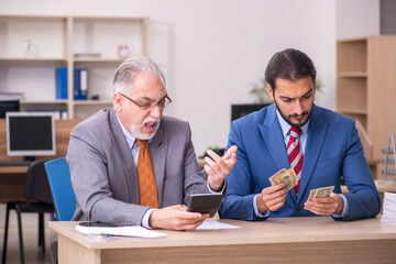 Two male employees in remuneration concept