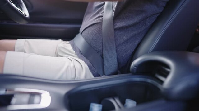 Close up shot of man buckle up car seatbelts, male driver get ready before driving, safe travel safety first, private transportation driver license, fasten seatbelt inside the vehicle, casual clothing