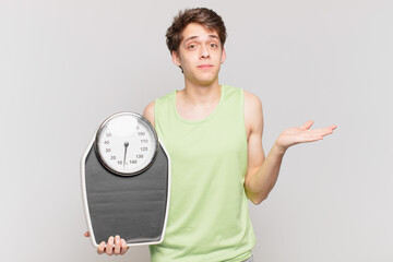 young boy feeling puzzled and confused, doubting, weighting or choosing different options with...