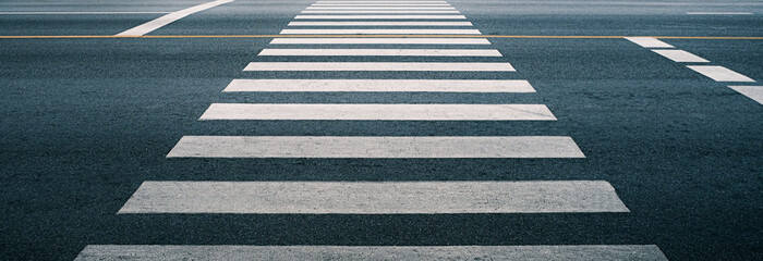 crosswalk on the road for safety when people walking cross the street, Pedestrian crossing on a repaired asphalt road, Crosswalk on the street for safety, logistic import export and transport industry