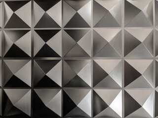 Background from hexagonal pyramids.seamless pattern in grey colors. Many small three-dimensional squares.