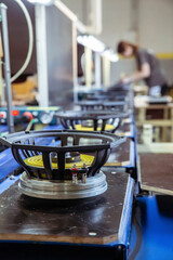 Musical speakers on a conveyor in a factory