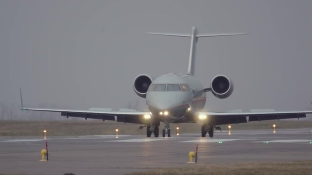 Business jet (bizjet or private jet charter) is taxiing on a runway after landing