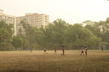 locals practice soccer in the morning at rabindra sarobor, a vast water body surrounded by parks and grounds with abundant of nature in kolkata, west bengal, india