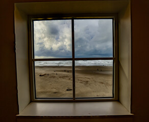 Looking through a window with four panes at the beach at Seaside on the Oregon coast