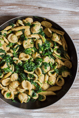 Wholemeal pasta with spinach in a pan. View from top.