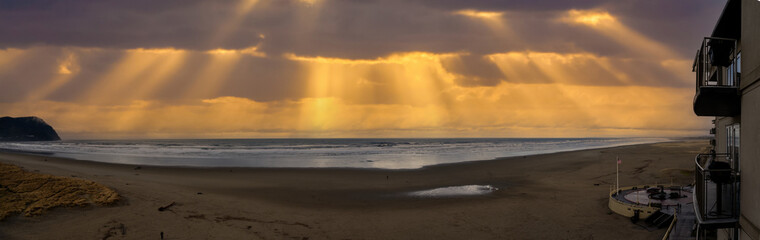 A panoramic image of the beach and promenade turnaround at sunset at Seaside Oregon