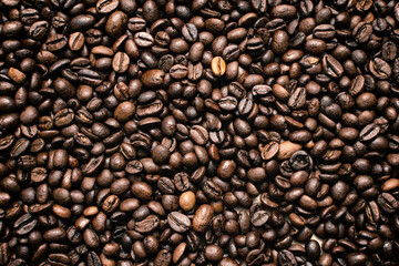 Coffee beans. Coffee beans are spread out on the surface.