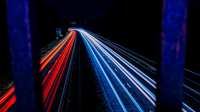 Freeway Light Trails through overpass bars © WD Stockphotos