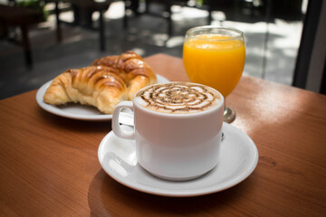 cup of coffee and croissant with orange juice