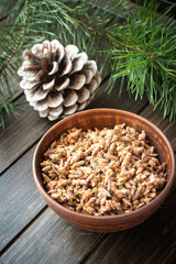 Healing decoction from pine kidneys. Dried pine buds. Medicinal tincture for colds. Vertical image