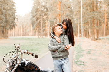 guy with a girl in the park on a motorcycle