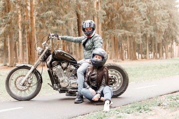 Fototapeta na wymiar guy with a girl in the park on a motorcycle