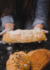 woman's hands with freshly kneaded homemade bread