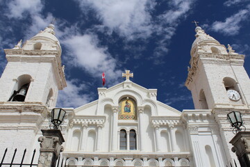 white doors of a church waiting for parishioners