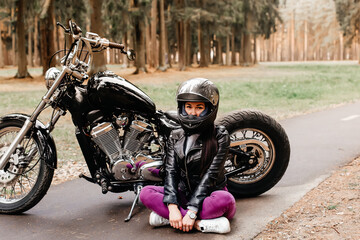 beautiful brunette riding a motorcycle in the park