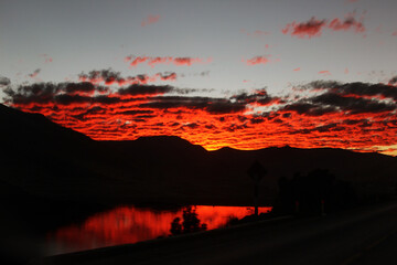 relaxing and stunning red sky at sunrise in front of the lake