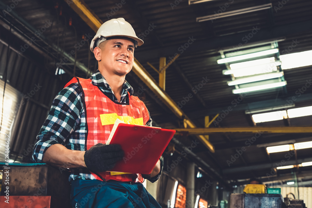 Poster manufacturing worker working with clipboard to do job procedure checklist . factory production line 