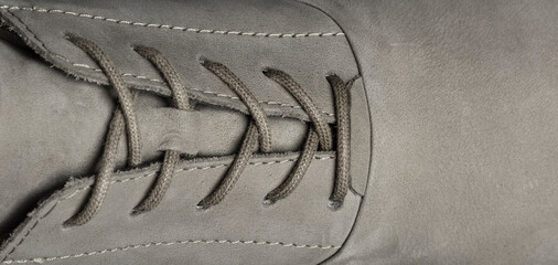 Laces on gray shoes with place for text, copy space. Detail of shoe closeup