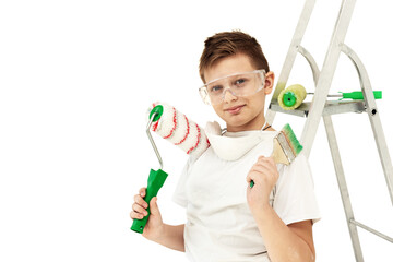 A boy with painting tools on a white background. Construction tools. Roller and stepladder.