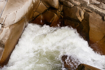 bubbling water and stones. Falling waterfall. Background texture