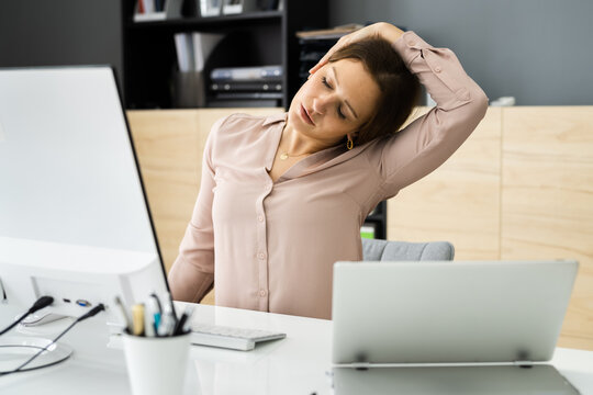 Woman Stretching At Office Desk