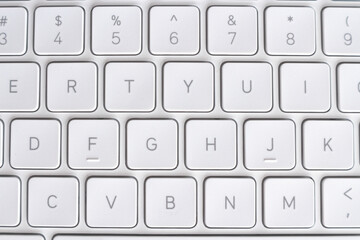 White keys of a laptop keyboard. White hi-tech background.