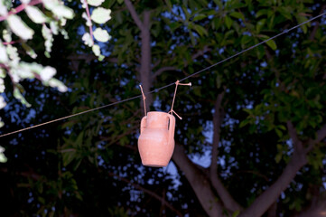 A pitcher hanging on a rope in the garden. Playful. 