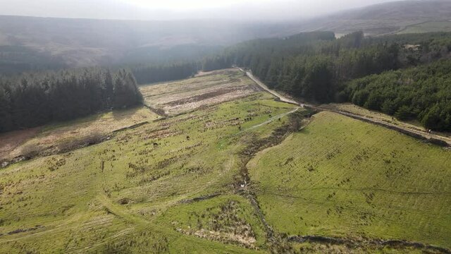 Aerial Drone View Forest Hike In Peak District West Yorkshire Holmfirth Yateholme With Walking trail and Misty Hills In Background