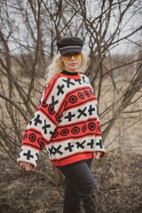 Woman wear hipster vintage sweater, black cap and glasses, trendy concept