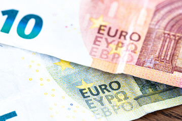 Euro money cash, 10 and 5 euro banknotes as a backdrop for topics such as economics, finance, savings and investment.