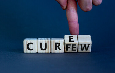 Curfew and cure symbol. Businessman turns cubes and changes the word 'curfew' to 'cure'. Beautiful grey background. Business, curfew and cure concept. Copy space.
