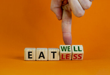 Eat well or eat less symbol. Businessman turns cubes and changes words 'eat less' to 'eat well'. Beautiful orange background. Business, eat well or less concept. Copy space.